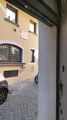 a door to a building with a motorcycle parked next to it at Trastevere Heritage Suite in Rome