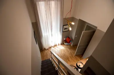 an overhead view of a room with a staircase and a window at Assunta Domus in Rome