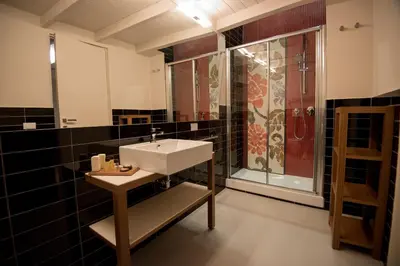 a bathroom with a sink and a shower at Assunta Domus in Rome