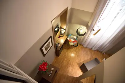 an overhead view of a room with a staircase and a mirror at Assunta Domus in Rome