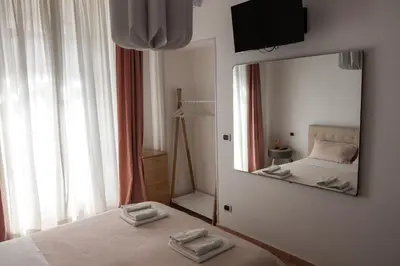 a bedroom with a bed and a large mirror at Casa Matteo53 Termini - Castro Pretorio in Rome