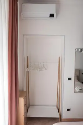 a room with a white door and a mirror at Casa Matteo53 Termini - Castro Pretorio in Rome