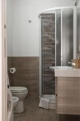a bathroom with a shower and a toilet and a sink at Casa Matteo53 Termini - Castro Pretorio in Rome