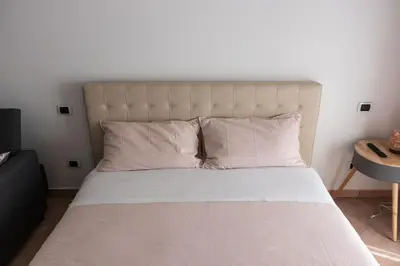 a bedroom with a large bed with white sheets and pillows at Casa Matteo53 Termini - Castro Pretorio in Rome