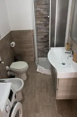 a bathroom with a toilet and a sink and a shower at Casa Matteo53 Termini - Castro Pretorio in Rome