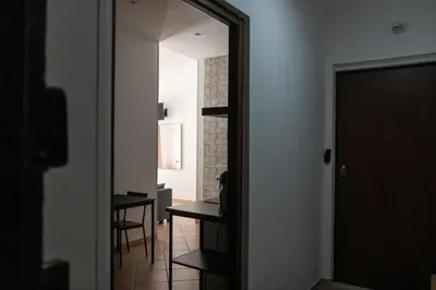 a hallway with a mirror and a table in a room at Casa Matteo53 Termini - Castro Pretorio in Rome