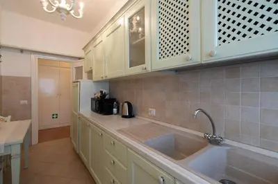 a kitchen with white cabinets and a sink at Kimera Luxury Apartments in Rome San Pietro in Rome