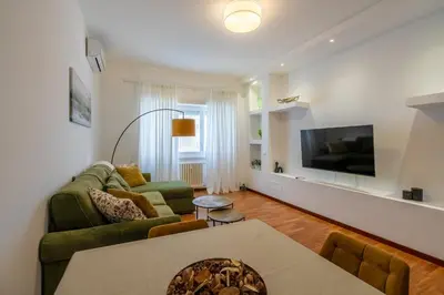 a living room with a couch and a tv at Kimera Luxury Apartments in Rome San Pietro in Rome