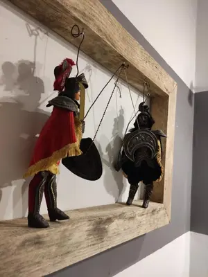 a shelf with two figurines in a wooden frame at Casa Mariella Quartiere Trionfale - Prati in Rome