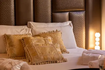 a bed with white pillows and a brown head board at Fontana di Trevi Roma Luxury Suite in Rome