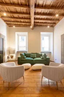 a living room with a green couch and two chairs at Fontana di Trevi Roma Luxury Suite in Rome