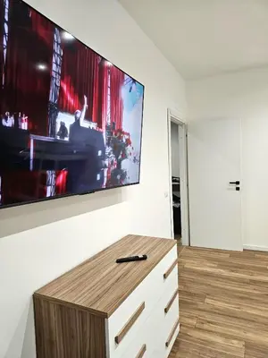 a living room with a large tv on a wall at Ricettiva Cipro San Pietro e Musei Vaticani in Rome