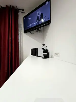 a flat screen tv hanging on a white wall at Ricettiva Cipro San Pietro e Musei Vaticani in Rome