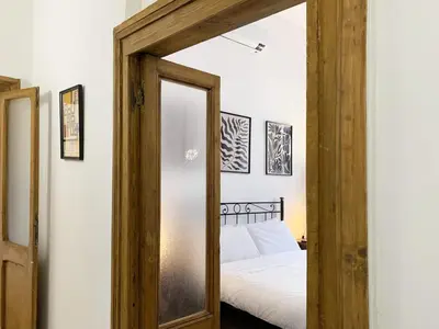 a bedroom with a mirror and a bed at RomeAsYouLike - Vatican Apartment N°73 in Rome