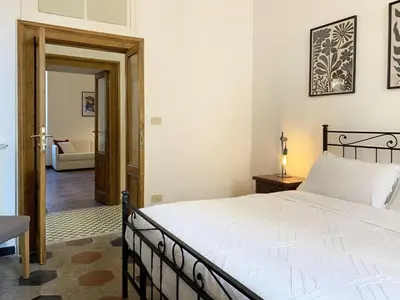 a bedroom with a bed and a living room at RomeAsYouLike - Vatican Apartment N°73 in Rome