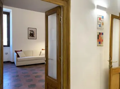 a living room with a white couch and a door at RomeAsYouLike - Vatican Apartment N°73 in Rome