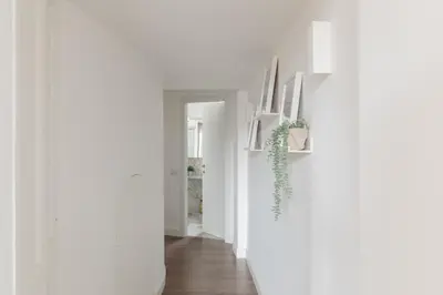 a hallway with white walls and wooden floors at iFlat Magnificent Central Apartment in Rome