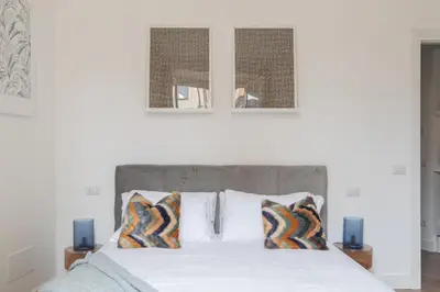 a bedroom with a bed with two pictures on the wall at iFlat Magnificent Central Apartment in Rome