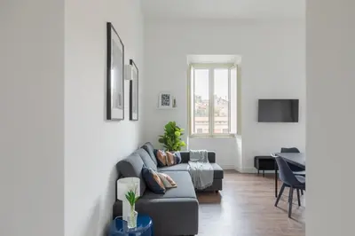 a living room with a couch and a table at iFlat Magnificent Central Apartment in Rome