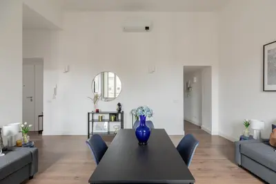a blue vase sitting on a table in a living room at iFlat Magnificent Central Apartment in Rome