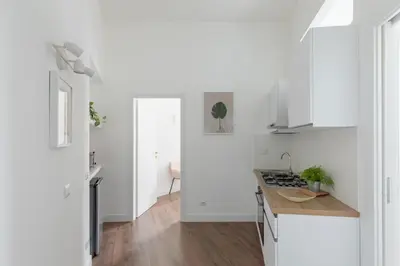 a kitchen with white cabinets and a counter top at iFlat Magnificent Central Apartment in Rome
