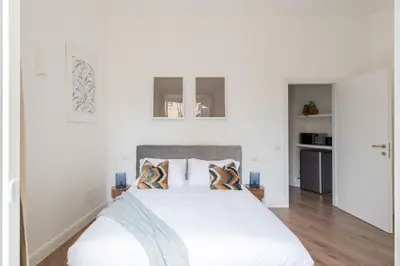 a bedroom with a large white bed with pillows at iFlat Magnificent Central Apartment in Rome