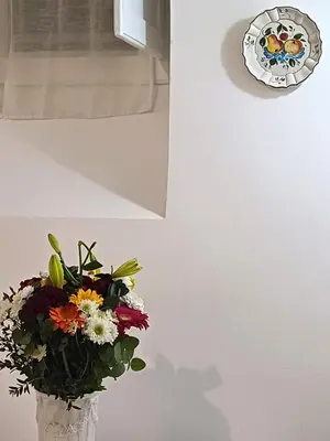a vase filled with flowers in a room at Gianicolo Sweet Home in Rome
