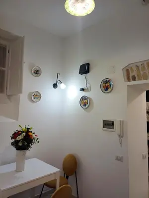 a kitchen with a table and plates on the wall at Gianicolo Sweet Home in Rome