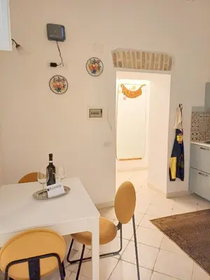 a kitchen with a table and chairs and a refrigerator at Gianicolo Sweet Home in Rome