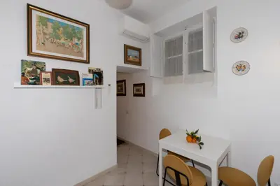 a dining room with a white table and chairs at Gianicolo Sweet Home in Rome