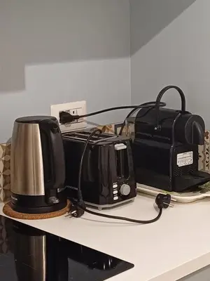 a counter with a toaster and a toaster and a toffeeper at Gianicolo Sweet Home in Rome