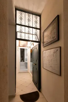 a hallway with a door with a window and a tile floor at Gianicolo Sweet Home in Rome