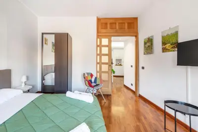 a bedroom with a bed and a chair and a mirror at Vista Cupola San Pietro - Stazione Roma S Pietro in Rome