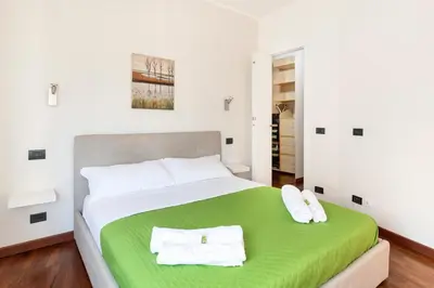 a bedroom with a bed with two towels on it at Vista Cupola San Pietro - Stazione Roma S Pietro in Rome