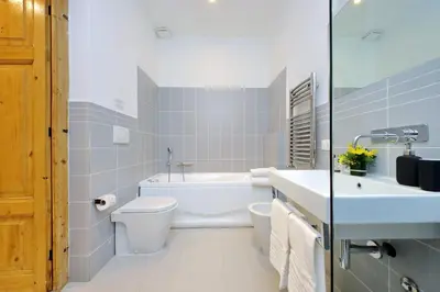 a bathroom with a tub and a toilet and a sink at TreasureRome Opera & Trevi Grand Suite 3BR in Rome