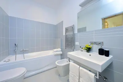 a bathroom with a sink and a tub and a toilet at TreasureRome Opera & Trevi Grand Suite 3BR in Rome