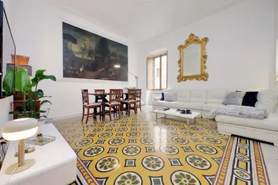 a living room with a couch and a table at TreasureRome Opera & Trevi Grand Suite 3BR in Rome