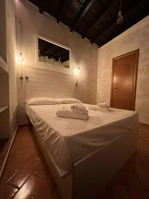 a bedroom with a large bed with towels on it at Magenta Collection Panico 32 in Rome
