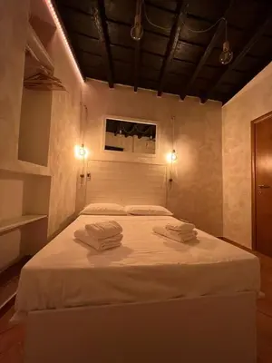 a bedroom with a white bed with two towels on it at Magenta Collection Panico 32 in Rome