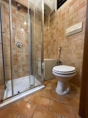 a bathroom with a toilet and a glass shower at Magenta Collection Panico 32 in Rome