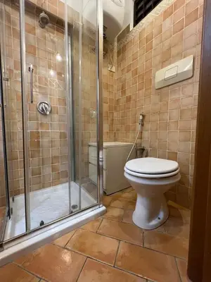 a bathroom with a toilet and a glass shower at Magenta Collection Panico 32 in Rome