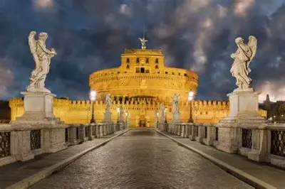 a large yellow building with statues on a bridge at Magenta Collection Panico 32 in Rome