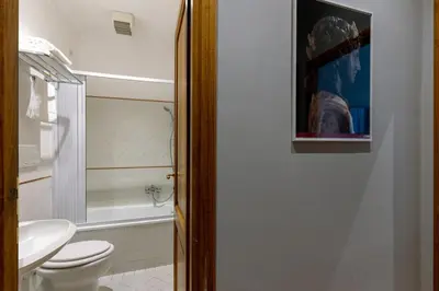 a bathroom with a toilet and a sink and a tub at River61 - Guest House in Rome
