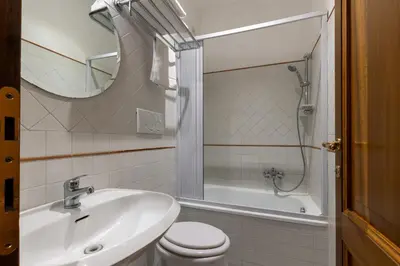 a bathroom with a sink and a toilet and a shower at River61 - Guest House in Rome