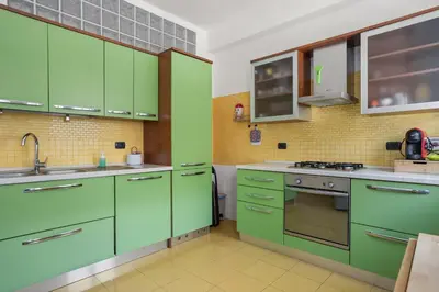 a bedroom with a bed and a desk with a computer at 543 Appia Avenue - Metro A by RHR in Rome