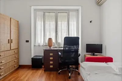a blue chair with a pillow in a room at 543 Appia Avenue - Metro A by RHR in Rome