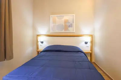 a bedroom with a bed with a blue blanket at Binario Zero in Rome