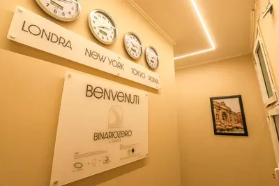 a room with clocks on the wall at Binario Zero in Rome