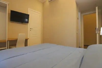 a bedroom with a bed and a tv on the wall at Binario Zero in Rome