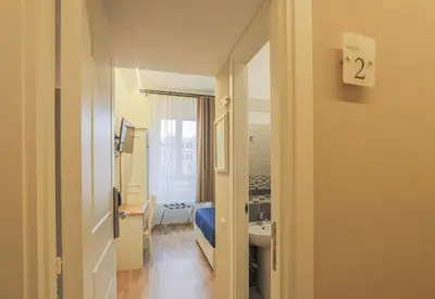 a room with a bathroom with a sink and a mirror at Binario Zero in Rome